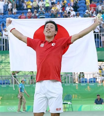 テニス男子シングルス３位決定戦ナダルに勝利、３位が決まり日の丸を掲げ喜ぶ錦織圭＝８月１４日、五輪テニスセンター（撮影・桐山弘太）